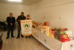 Garcia (C) e Goulart entregam os alimentos  representante da Pastoral da Criana