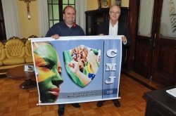 Ricardo (E) e Gil posam para foto segurando banner da CMJ
